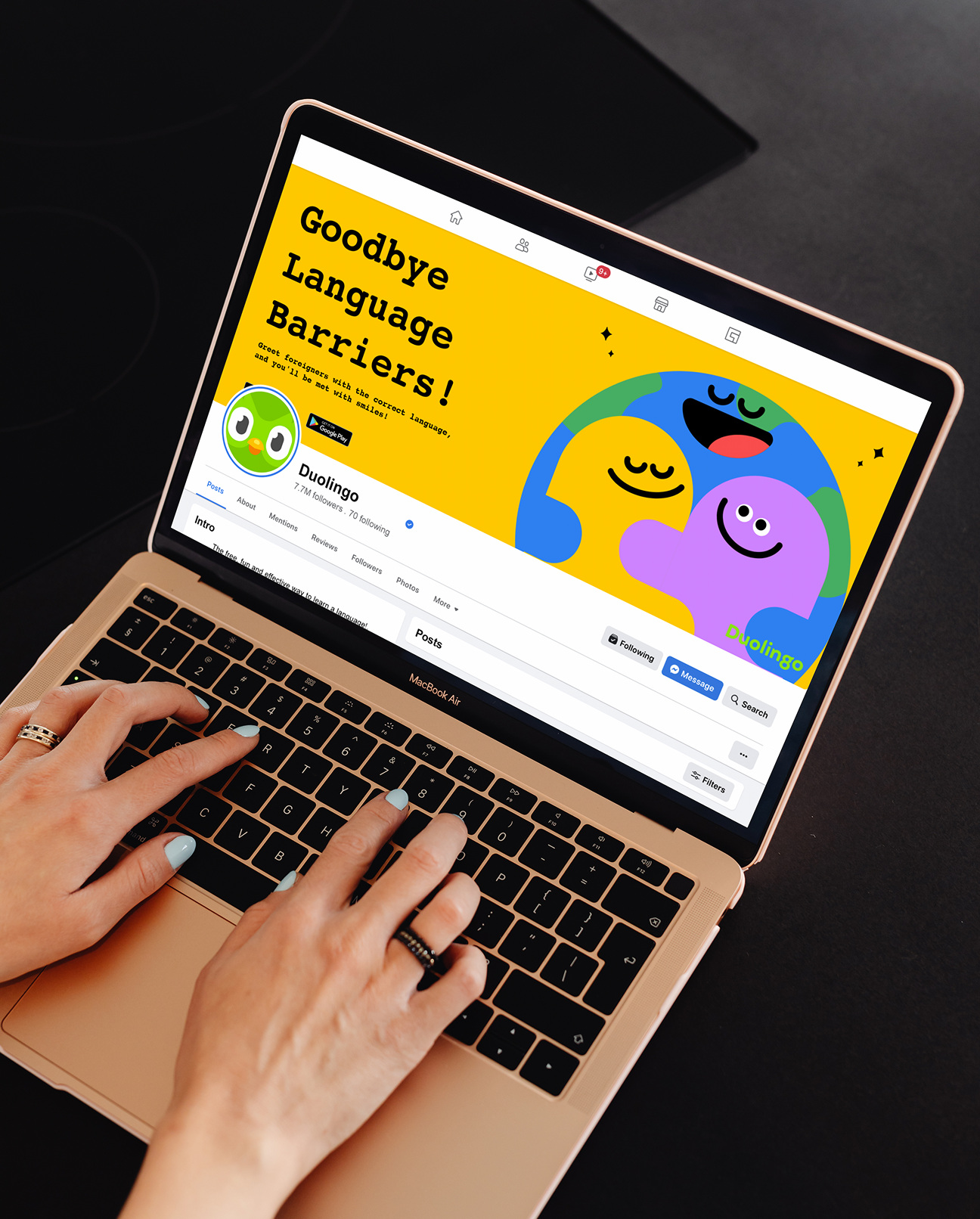 Person browsing the Duolingo Facebook page on a laptop